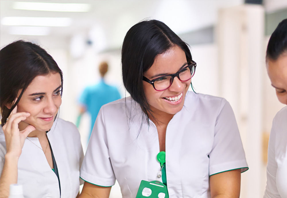 2 staff members smiling